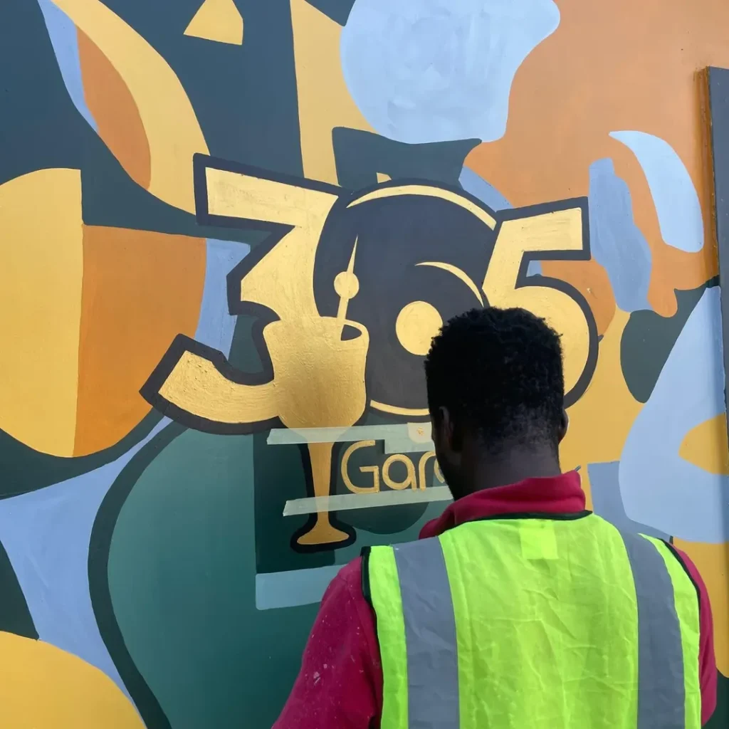 A Cedar Creative Artist Painting a Mural on a Wall